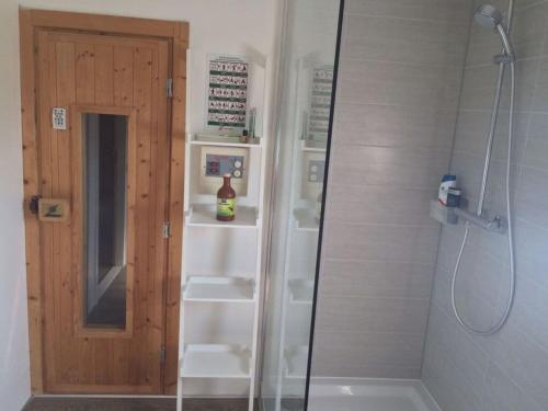 a shower with a glass door in a bathroom at Villa Sunlight Comfortable Vacation Home in Makkum