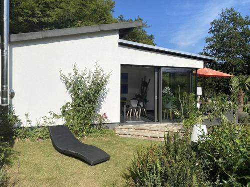 a house with a black slide in the yard at Design and art Comfortable holiday residence in Schlangenbad