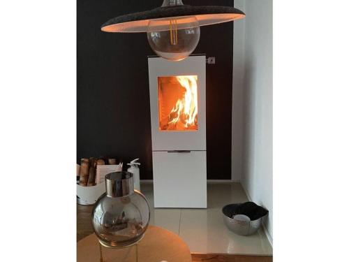 a kitchen with a fire in a stove at Design and art Comfortable holiday residence in Schlangenbad
