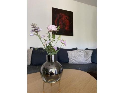 a vase with flowers sitting on top of a table at Design and art Comfortable holiday residence in Schlangenbad