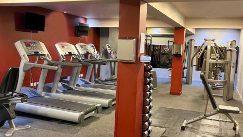 a gym with a row of treadmills and machines at Holiday Inn Aberdeen West by IHG in Westhill 