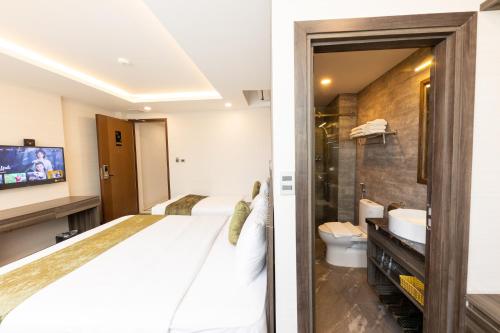 a hotel room with a bed and a bathroom at 3T Hotel Hanoi in Hanoi