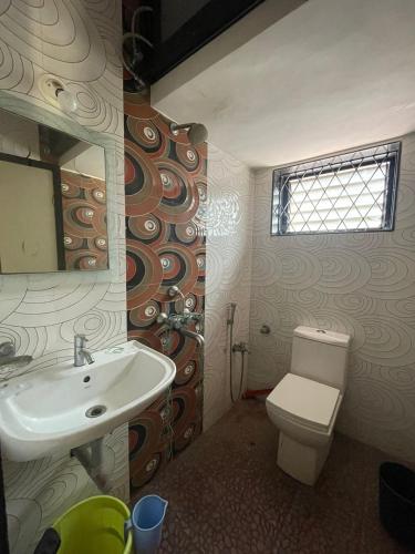 a bathroom with a sink and a toilet at 2bhk luxury baga candolim anjuna in North goa