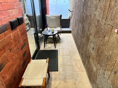a small table and a chair on a patio at Flowering Villa in Xiaoliuqiu