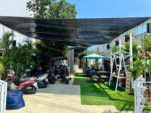 a patio with motorcycles parked in front of a house at Flowering Villa in Xiaoliuqiu