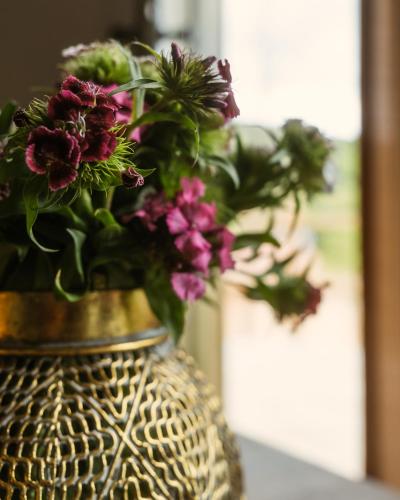 a vase filled with flowers sitting on a table at Eko Zaseok Brana in Rekovac