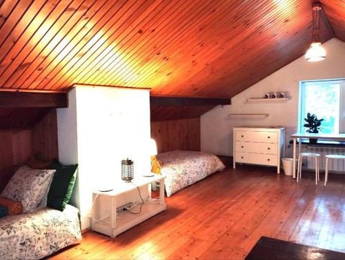 a bedroom with two beds and a wooden ceiling at Nest 4 Rest in Konstancin-Jeziorna