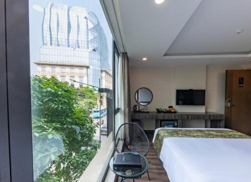 a hotel room with a view of a building at 3T Hotel Hanoi in Hanoi