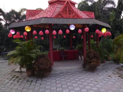 a gazebo with pink lanterns on it at Hotel Sangam in Baharampur