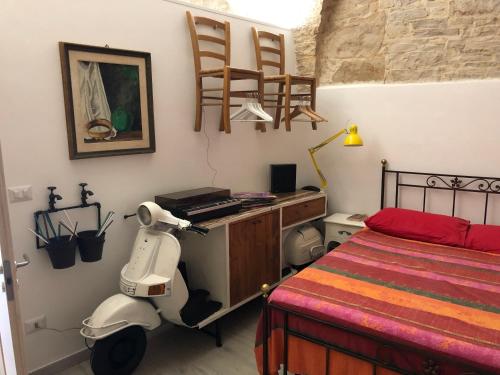 een slaapkamer met een scooter naast een bed bij La piccola casa di Tania in via Fiore in Terlizzi
