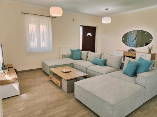 a living room with a couch and a table at Lucy's luxury II in Néa Koútali