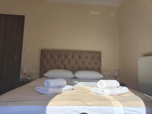 a bedroom with a bed with towels on it at Lucy's luxury II in Néa Koútali