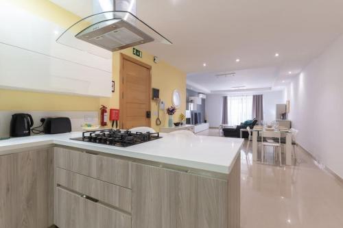 a kitchen and living room with a stove top at St Julians apartment-Hosted by Sweetstay in St Julian's