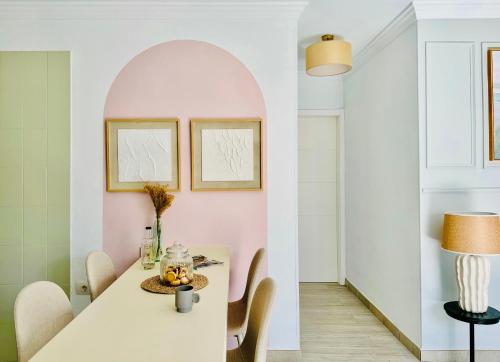 a dining room with a white table and chairs at Canaryislandshost l Sal de Mar in Puerto del Carmen