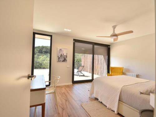 a bedroom with a bed and a view of a patio at Villa Clarisse in Tamariu
