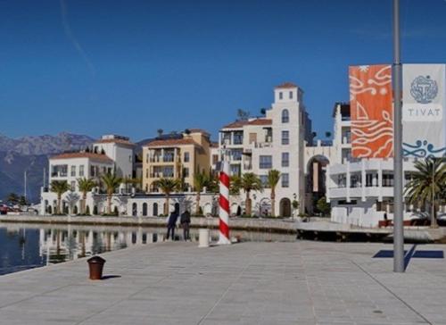 a group of buildings next to a body of water at Apartment Riva in Tivat