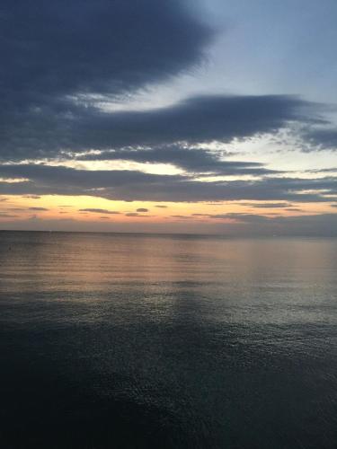 a sunset over the water with a cloudy sky at Hotel Athena in Pesaro