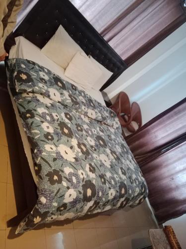 a bed with a pillow with a cow print at AL KHALEEJ HOTEL in Murree