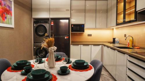 a kitchen with a table with green dishes on it at Imperial Luxury Suites KLCC by Moonway in Kuala Lumpur