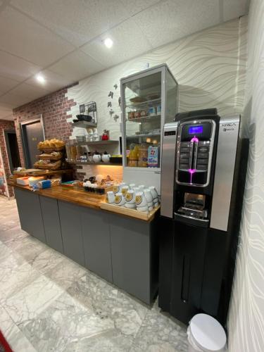 a kitchen with a counter with aasteryasteryasteryasteryasteryasteryasteryasteryastery at Savoie Hotel aux portes de Genève in Saint-Julien-en-Genevois