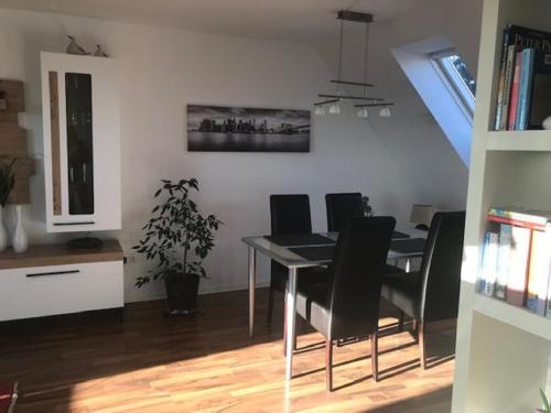 a dining room with a table and black chairs at Ferienwohnung Schmidbauer in Beilngries