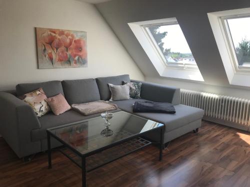 a living room with a couch and a glass table at Ferienwohnung Schmidbauer in Beilngries