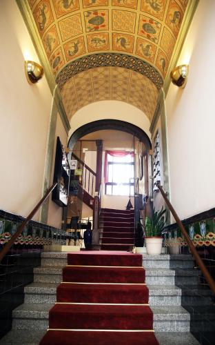 a staircase in a building with a coffered ceiling at Hotel Alt-Connewitz in Leipzig