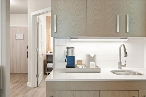 a kitchen with a sink and a counter top at EVEN Hotel Austin Uptown near the Domain, an IHG Hotel in Austin