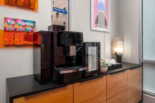 a coffee machine sitting on top of a counter at City Limits Hotel Apartments in Melbourne