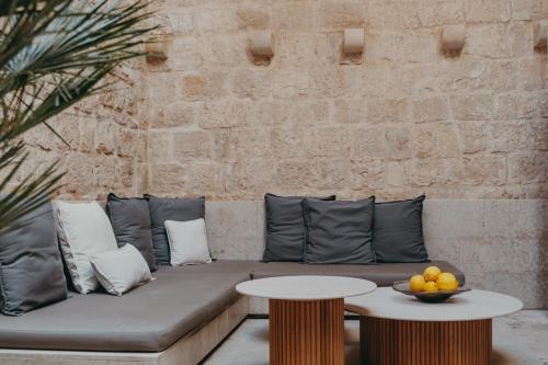 a couch and two tables with a bowl of fruit on it at Lesic Dimitri Palace in Korčula