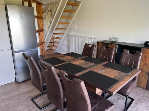 a kitchen with a table and chairs and a refrigerator at Ferienwohnung Seeblick in Retgendorf