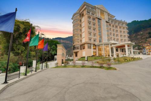a large building with flags in front of it at Lemon Tree Premier Budhanilkantha Kathmandu, Nepal in Kathmandu