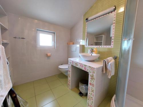a bathroom with a sink and a toilet at Apartment Dumica in Malinska