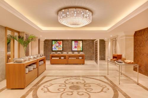 a large kitchen with a chandelier in a room at Lemon Tree Premier Budhanilkantha Kathmandu, Nepal in Kathmandu