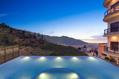 a house with a swimming pool with a view at Lemon Tree Premier Budhanilkantha Kathmandu, Nepal in Kathmandu