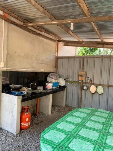 an outdoor kitchen with a table and a stove at LOKI'S APARTMENT in Catarman