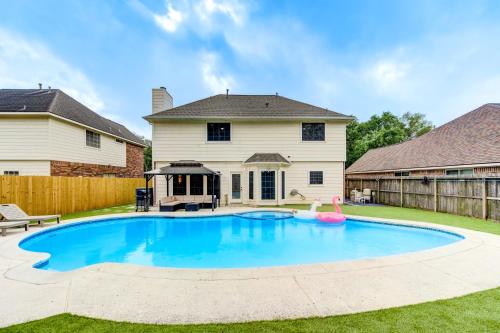 a swimming pool in the yard of a house at Amazing Getaway Home - 4 Bedrooms 2,5 Baths - West Houston, Katy, Richmond - Huge Pool, Mini-Golf, PingPong, Billards, BBQ, Katy Asian Town, Typhoon Waterpark, King Bed in Katy