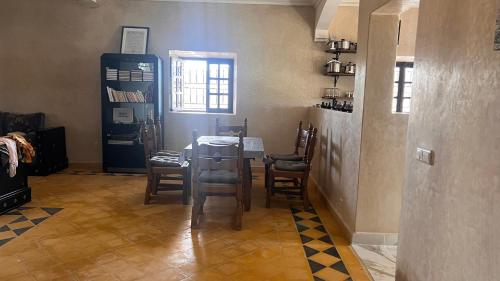 a room with a table and chairs and a window at Escapade famille - vue panoramique et piscine privée in Aït Ghemat