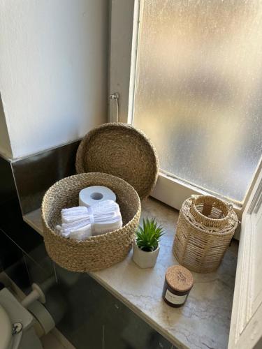 a bathroom with baskets and towels on a shelf at Civico168 in Castellammare del Golfo
