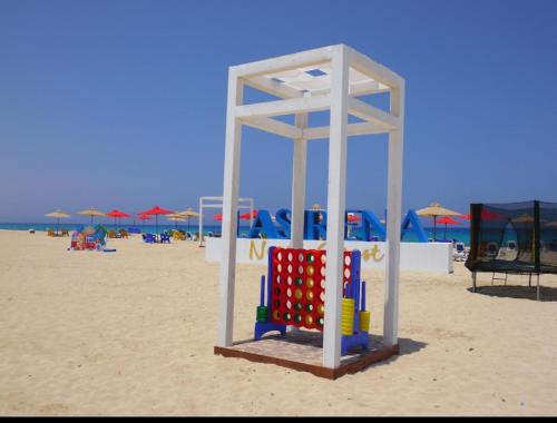 a play structure on a beach with anophe at Lasirena north coast Chalet With Roof , 3 rooms in Zāwiyat ‘Abd al Mun‘im