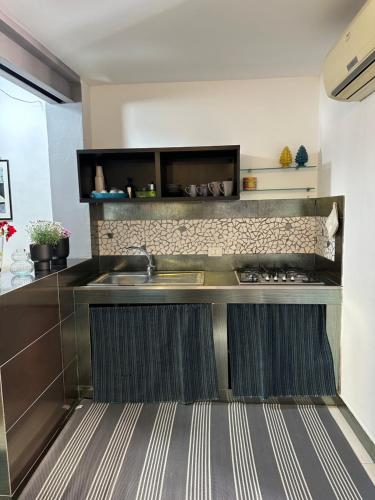 a kitchen with a sink and a counter at Civico168 in Castellammare del Golfo