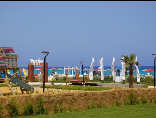 a park with a slide and a playground at Lasirena north coast Chalet With Roof , 3 rooms in Zāwiyat ‘Abd al Mun‘im