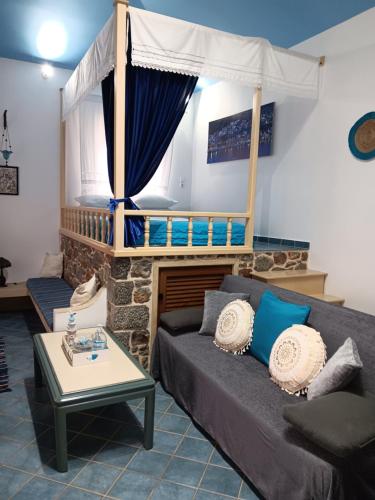 a living room with a couch and a fireplace at Villa Anna in Skaliá