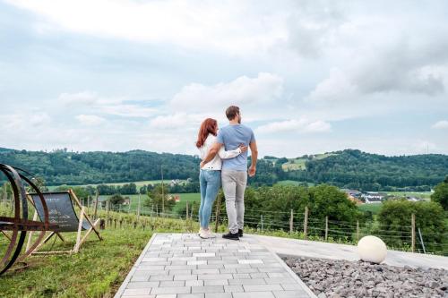 a man and a woman standing on top of a hill at das MEISTER in Riegersburg