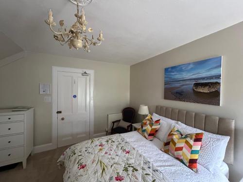 a bedroom with a bed and a chandelier at Glen Lyon Lodge Bed and Breakfast in Nairn