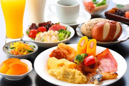 einen Tisch mit Frühstücksteller und Getränken in der Unterkunft Route Inn Grantia Tokai Spa&Relaxation in Tokai