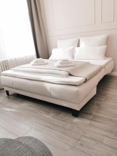 a large white bed sitting in a room at GELI Homes L1 - 2x Zimmer, 2x Kingsize Bett, 1 bis 4 Personen, Parkplatz, TV, Wifi, top Küche, Kaffee, Tee in Lünen
