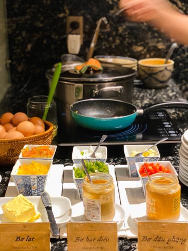 a table topped with different types of food in containers at Amanaki Saigon Boutique Hotel in Ho Chi Minh City