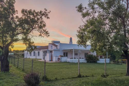a rainbow in the sky over a white house at Quinta da Foz - Vivenda Amélia in Foz
