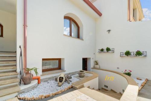a living room with a fireplace and stairs at Villa Fraisca in Sanluri